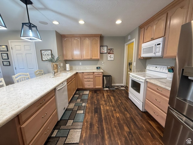 5140 S 2175 W, Roy, UT 84067 - kitchen featuring white appliances, light brown cabinetry, recessed lighting, a peninsula, and hanging light fixtures