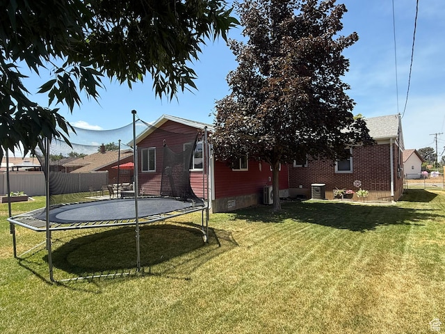 5140 S 2175 W, Roy, UT 84067 - back of property with a trampoline and brick siding