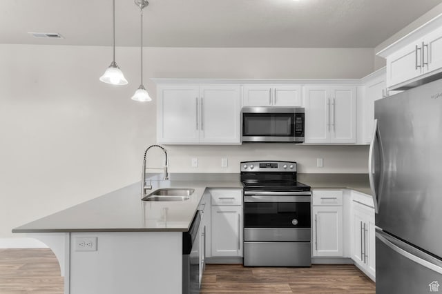 14643 S Mckellen Dr Unit D202, Herriman, UT 84096 - kitchen with stainless steel appliances, a peninsula, and white cabinets