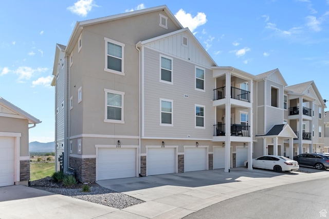 14643 S Mckellen Dr Unit D202, Herriman, UT 84096 - view of building exterior featuring an attached garage and driveway