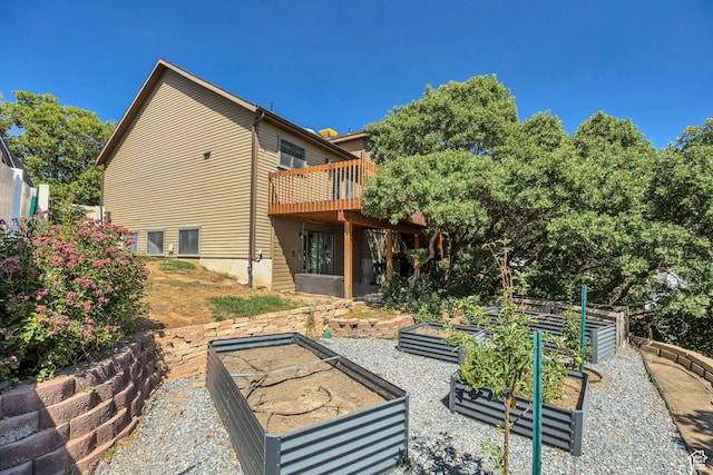 2140 E 3000 N, Layton, UT 84040 - rear view of property featuring a vegetable garden and a wooden deck