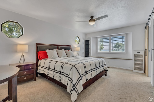 2140 E 3000 N, Layton, UT 84040 - bedroom with light carpet, ceiling fan, a barn door, and a textured ceiling