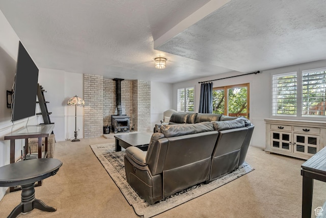 2140 E 3000 N, Layton, UT 84040 - living area featuring a wood stove, a textured ceiling, and carpet floors