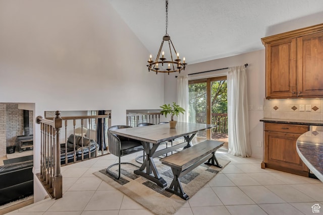 2140 E 3000 N, Layton, UT 84040 - dining area with a chandelier, light tile patterned floors, a wood stove, high vaulted ceiling, and a textured ceiling