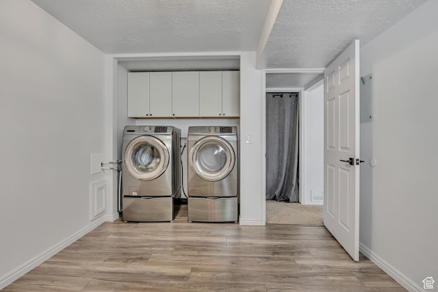 2140 E 3000 N, Layton, UT 84040 - laundry room featuring independent washer and dryer, a textured ceiling, cabinet space, and light wood-style floors