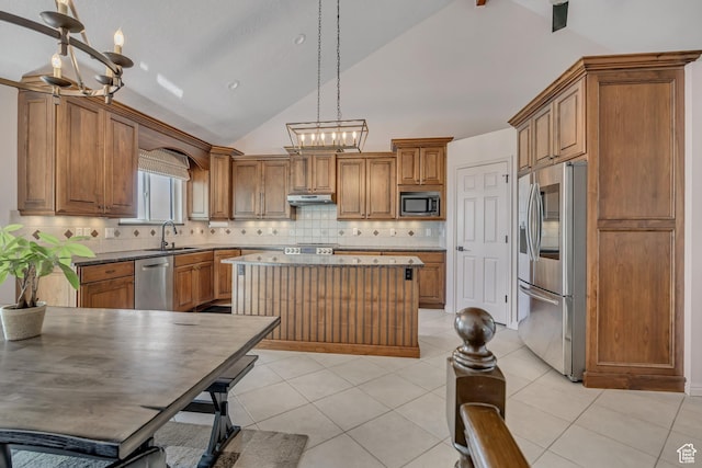2140 E 3000 N, Layton, UT 84040 - kitchen featuring stainless steel appliances, a chandelier, lofted ceiling, brown cabinets, and a center island