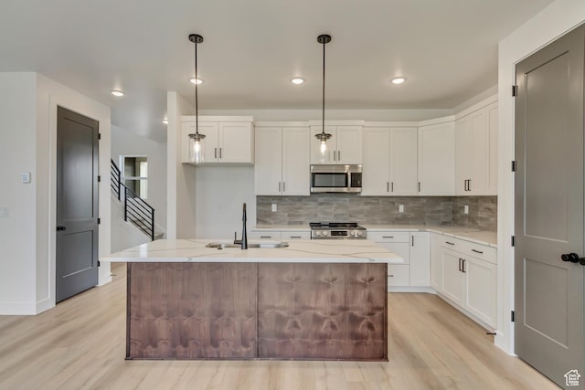 1344 N 1525 E Unit 73, Payson, UT 84651 - kitchen with stainless steel microwave, light wood-type flooring, stove, tasteful backsplash, and recessed lighting