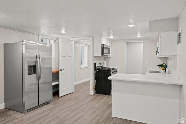 791 W 100 S, Provo, UT 84601 - kitchen with appliances with stainless steel finishes, white cabinets, light wood finished floors, and light countertops