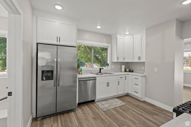 791 W 100 S, Provo, UT 84601 - kitchen with appliances with stainless steel finishes, light wood-style floors, light countertops, white cabinets, and recessed lighting