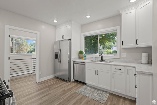 791 W 100 S, Provo, UT 84601 - kitchen featuring appliances with stainless steel finishes, light wood-style flooring, light countertops, white cabinets, and recessed lighting