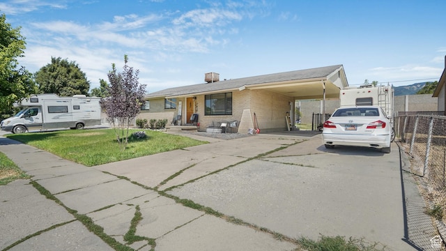 2075 Sorrento Dr, Woods Cross, UT 84087 - view of front of house with driveway, brick siding, a carport, and a chimney