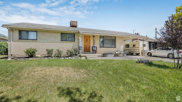 2075 Sorrento Dr, Woods Cross, UT 84087 - view of front of property featuring a front lawn, brick siding, and a chimney