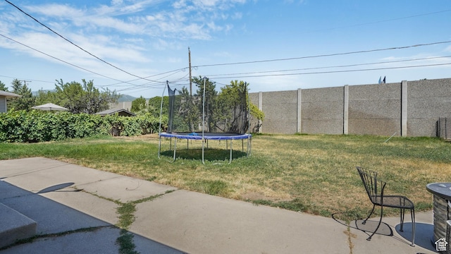 2075 Sorrento Dr, Woods Cross, UT 84087 - view of yard featuring a trampoline and a patio