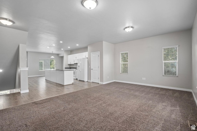 14728 S Rising Star Way W, Bluffdale, UT 84065 - unfurnished living room with dark colored carpet and recessed lighting