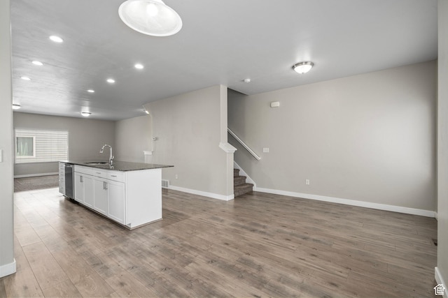 14728 S Rising Star Way W, Bluffdale, UT 84065 - kitchen with dark countertops, open floor plan, wood finished floors, recessed lighting, and white cabinets