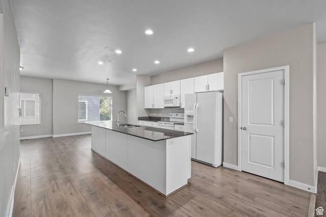 14728 S Rising Star Way W, Bluffdale, UT 84065 - kitchen featuring white appliances, wood finished floors, white cabinets, recessed lighting, and a center island with sink