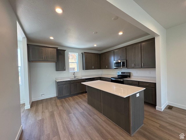 1452 N 1875 W Unit 146, Layton, UT 84041 - kitchen with stainless steel appliances, dark brown cabinets, wood finished floors, light countertops, and recessed lighting