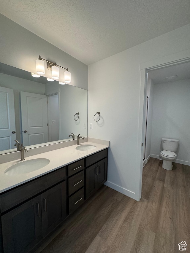 1452 N 1875 W Unit 146, Layton, UT 84041 - bathroom featuring wood finished floors, double vanity, and a textured ceiling