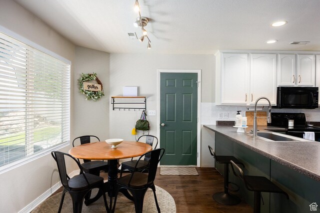 6733 W Mary Leizan Ln, Herriman, UT 84096 - dining space with dark wood-style floors, recessed lighting, and track lighting