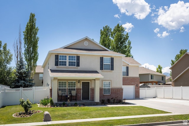 6733 W Mary Leizan Ln, Herriman, UT 84096 - traditional-style home with concrete driveway, brick siding, stucco siding, covered porch, and a garage