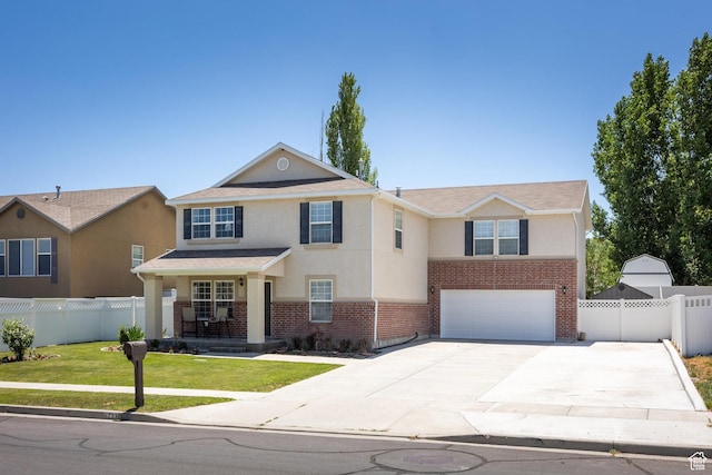 6733 W Mary Leizan Ln, Herriman, UT 84096 - view of front of house with an attached garage, brick siding, stucco siding, and driveway