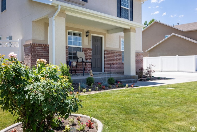 6733 W Mary Leizan Ln, Herriman, UT 84096 - property entrance with brick siding, covered porch, and stucco siding