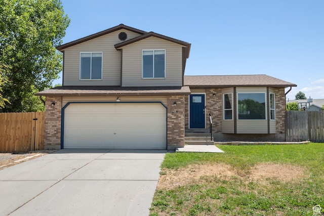 5131 W Parr Dr, West Jordan, UT 84081 - view of front facade featuring an attached garage, concrete driveway, brick siding, and entry steps