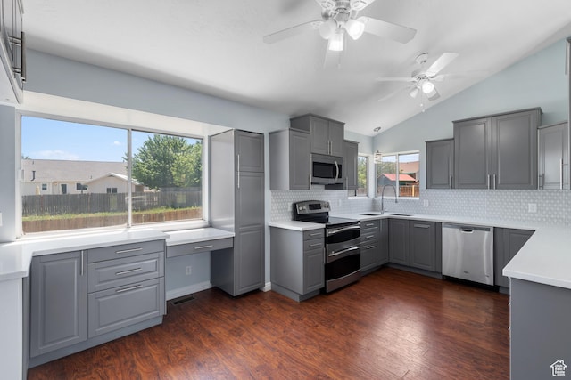 5131 W Parr Dr, West Jordan, UT 84081 - kitchen with appliances with stainless steel finishes, gray cabinetry, lofted ceiling, a ceiling fan, and backsplash