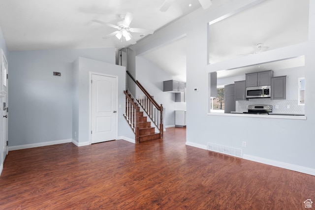 5131 W Parr Dr, West Jordan, UT 84081 - unfurnished living room with ceiling fan, lofted ceiling, stairway, and dark wood-style flooring