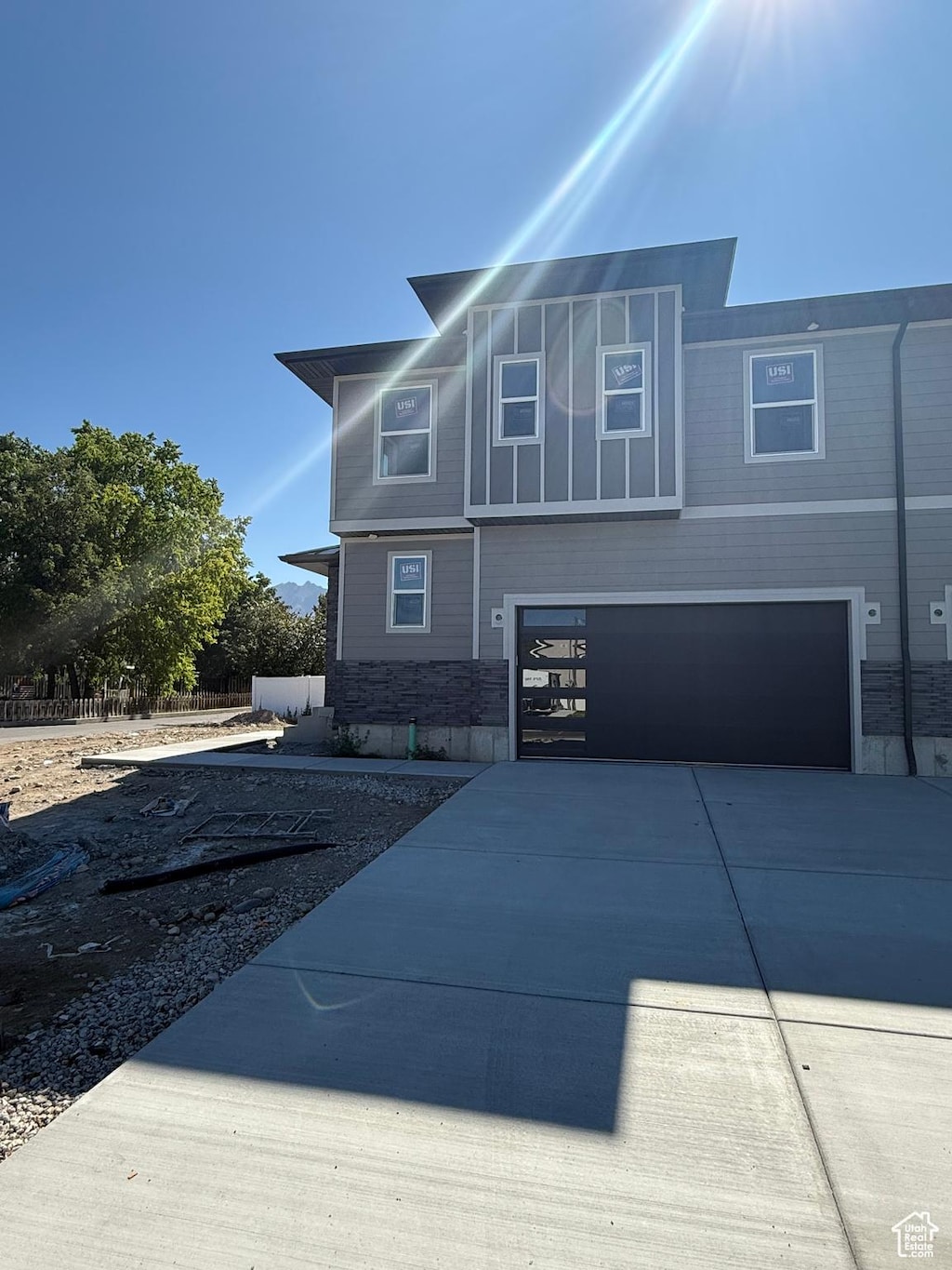 7425 S 410 E, Midvale, UT 84047 - view of front of home featuring an attached garage, concrete driveway, and stone siding