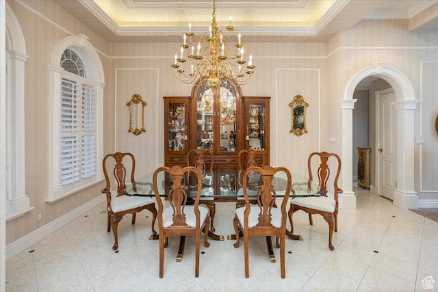 27 Canterbury Ln, Logan, UT 84321 - dining room featuring a chandelier, arched walkways, ornamental molding, light tile patterned flooring, and a raised ceiling