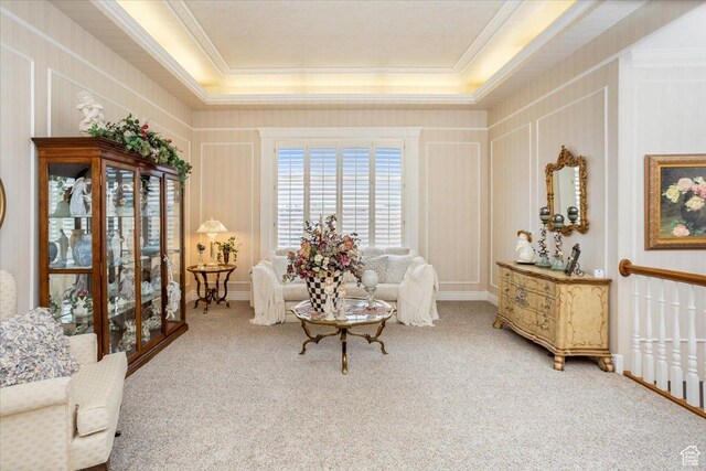 27 Canterbury Ln, Logan, UT 84321 - sitting room with carpet, ornamental molding, a tray ceiling, and a decorative wall