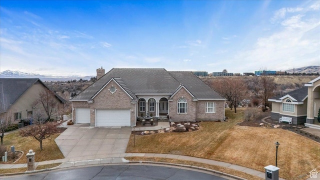 27 Canterbury Ln, Logan, UT 84321 - view of front of home featuring concrete driveway, a garage, a tiled roof, a chimney, and a front yard