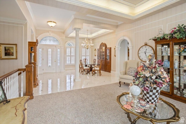 27 Canterbury Ln, Logan, UT 84321 - foyer entrance with a chandelier, crown molding, decorative columns, tile patterned floors, and arched walkways