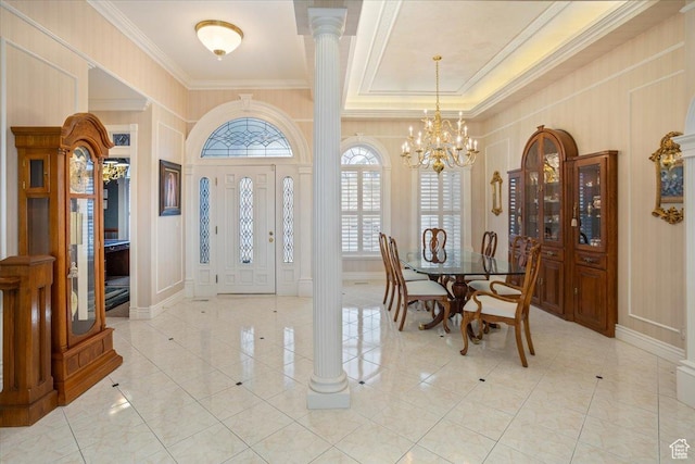 27 Canterbury Ln, Logan, UT 84321 - entryway with a decorative wall, crown molding, a chandelier, ornate columns, and light tile patterned floors