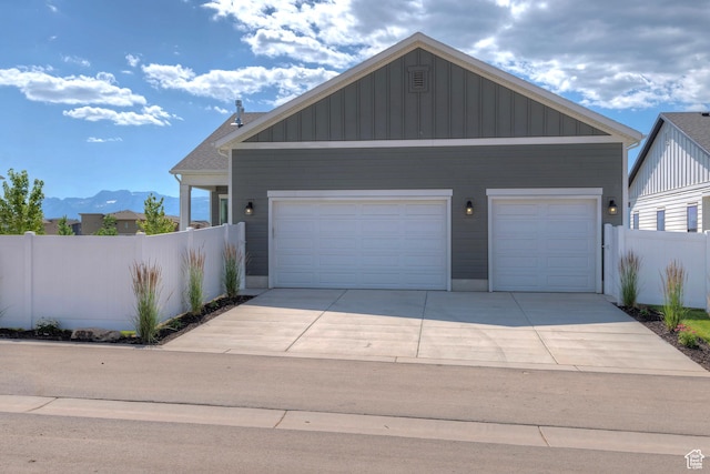 1919 S Sawmill Blvd E, Heber City, UT 84032 - view of front of property with a garage, board and batten siding, and a mountain view