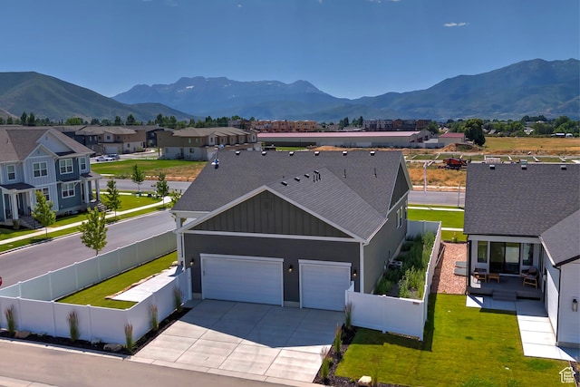 1919 S Sawmill Blvd E, Heber City, UT 84032 - view of front facade featuring driveway, a garage, a mountain view, board and batten siding, and a shingled roof