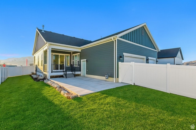 1919 S Sawmill Blvd E, Heber City, UT 84032 - rear view of house featuring board and batten siding, a fenced backyard, and a patio