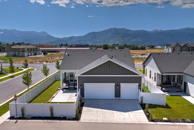1919 S Sawmill Blvd E, Heber City, UT 84032 - view of front of property with board and batten siding, a garage, a mountain view, and concrete driveway
