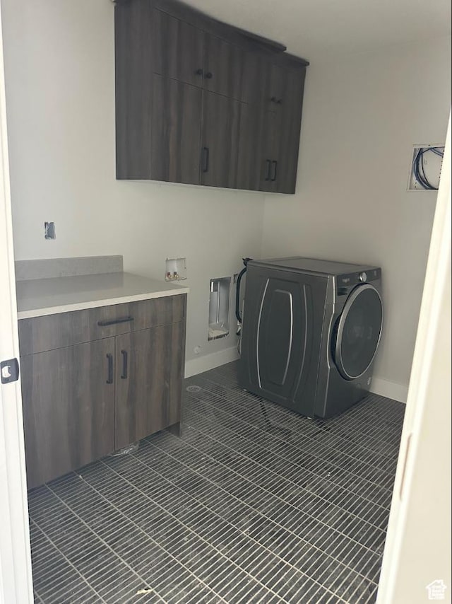 2655 S 2430 W Unit 116, Syracuse, UT 84075 - washroom featuring cabinet space, washer / clothes dryer, and dark tile patterned floors