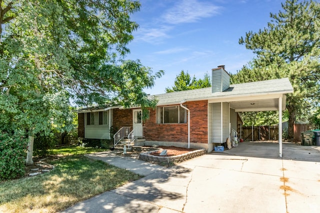 1844 Sorrento Dr, Woods Cross, UT 84087 - ranch-style home with driveway, a carport, a chimney, and brick siding