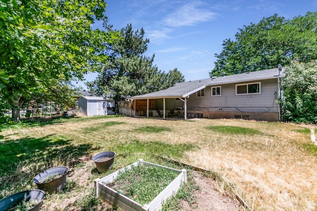 1844 Sorrento Dr, Woods Cross, UT 84087 - view of green lawn featuring a shed and a garden