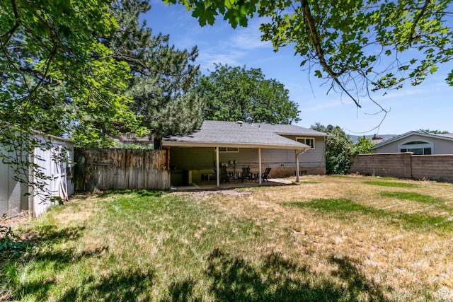 1844 Sorrento Dr, Woods Cross, UT 84087 - fenced backyard featuring a patio and a storage unit
