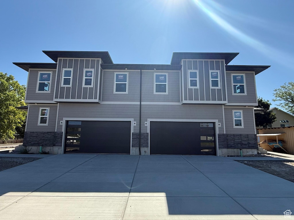 7433 S 410 E, Midvale, UT 84047 - view of front of home with a garage, driveway, and stone siding