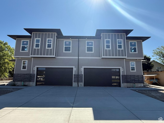 7433 S 410 E, Midvale, UT 84047 - view of front of home with a garage, driveway, and stone siding