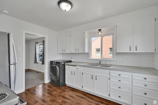 363 E Factory St, Garland, UT 84312 - kitchen with freestanding refrigerator, washer / clothes dryer, dark wood-type flooring, white cabinetry, and tasteful backsplash