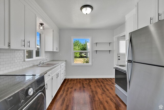 363 E Factory St, Garland, UT 84312 - kitchen with freestanding refrigerator, range, white range with electric stovetop, decorative backsplash, and dark wood-style floors