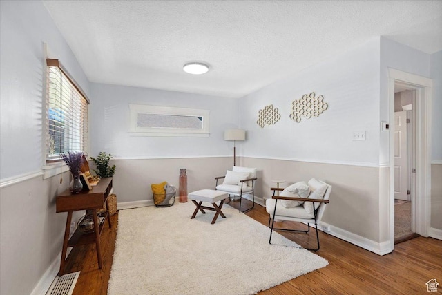 851 E Elm Ave, Salt Lake City, UT 84106 - sitting room with wood finished floors and a textured ceiling