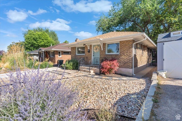 851 E Elm Ave, Salt Lake City, UT 84106 - view of front facade with a storage unit, brick siding, and a chimney