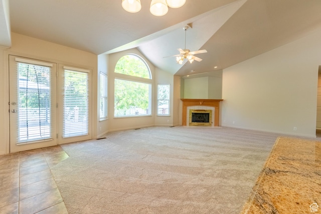 571 E Golden Pheasant Dr, Draper, UT 84020 - unfurnished living room with ceiling fan, a tiled fireplace, light colored carpet, and high vaulted ceiling